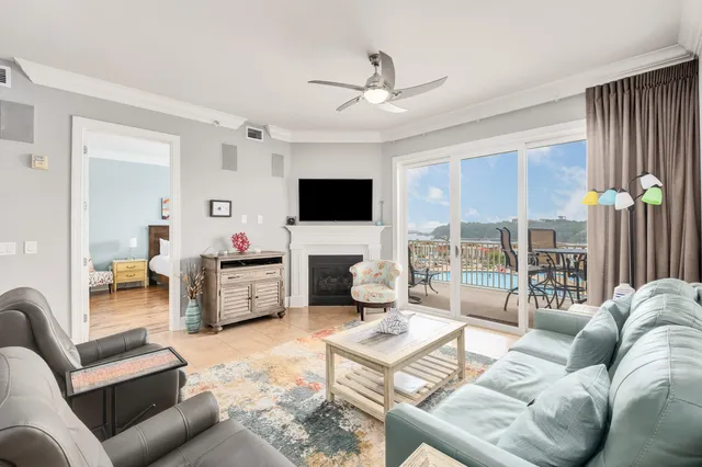a living room with furniture a flat screen tv and a large window