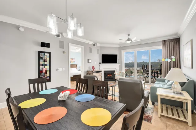 a view of a dining room with furniture a kitchen and chandelier