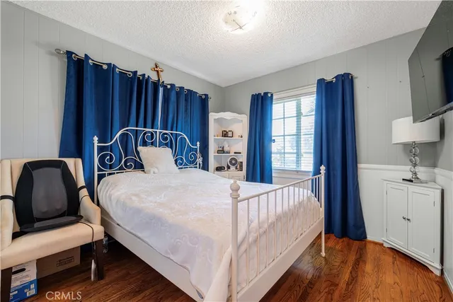 a bedroom with a bed next to a window with outer view