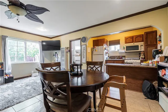 a dining room with furniture and wooden floor