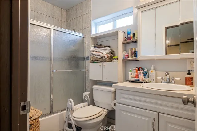 a bathroom with a sink a toilet and a shower curtain