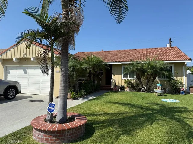 a front view of a house with a garden and patio