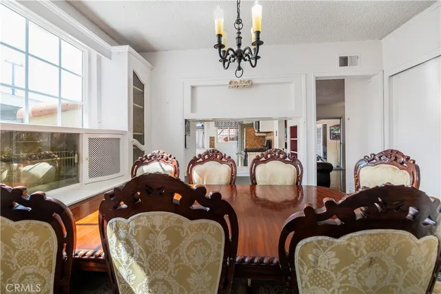a bedroom with two beds and potted plants