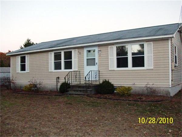 17 Palmer Road Pepperell, MA 01463 - Photo 1 of 1 a front view of a house with a yard