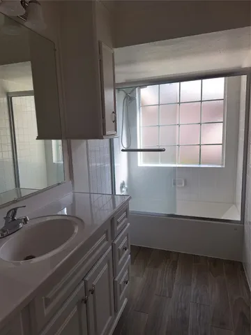 a bathroom with a sink and a large mirror