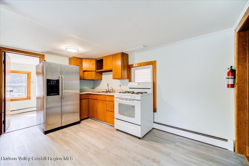 385 Main Street Rosendale, NY 12472 - Photo 5 of 23 a kitchen with stainless steel appliances a stove a sink and a refrigerator