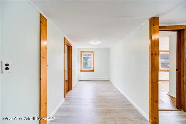 a view of hallway with wooden floor