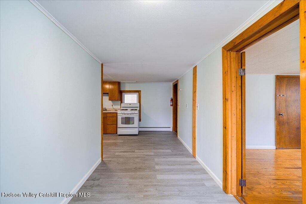 385 Main Street Rosendale, NY 12472 - Photo 8 of 23 a view of a hallway with wooden floor and a bathroom