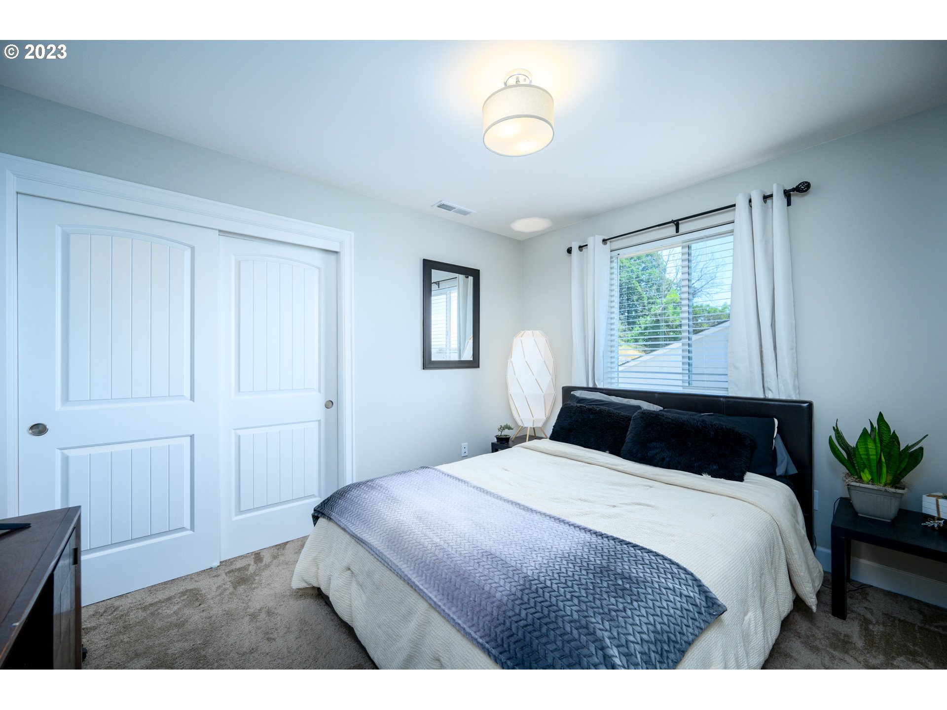501 Merlot Street Amity, OR 97101 - Photo 21 of 44 a bedroom with a bed and a potted plant