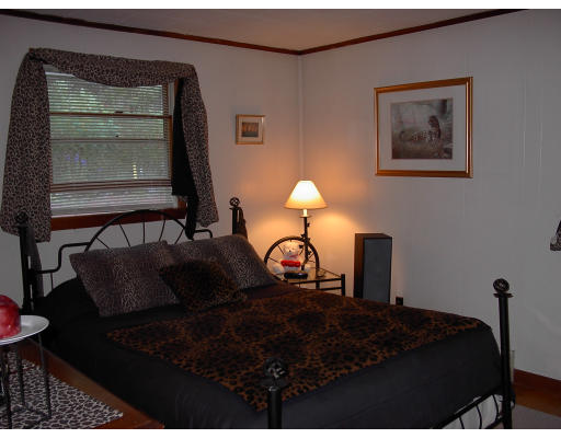 4 East River Road Chester, MA 01050 - Photo 5 of 12 a bedroom with bed and a window