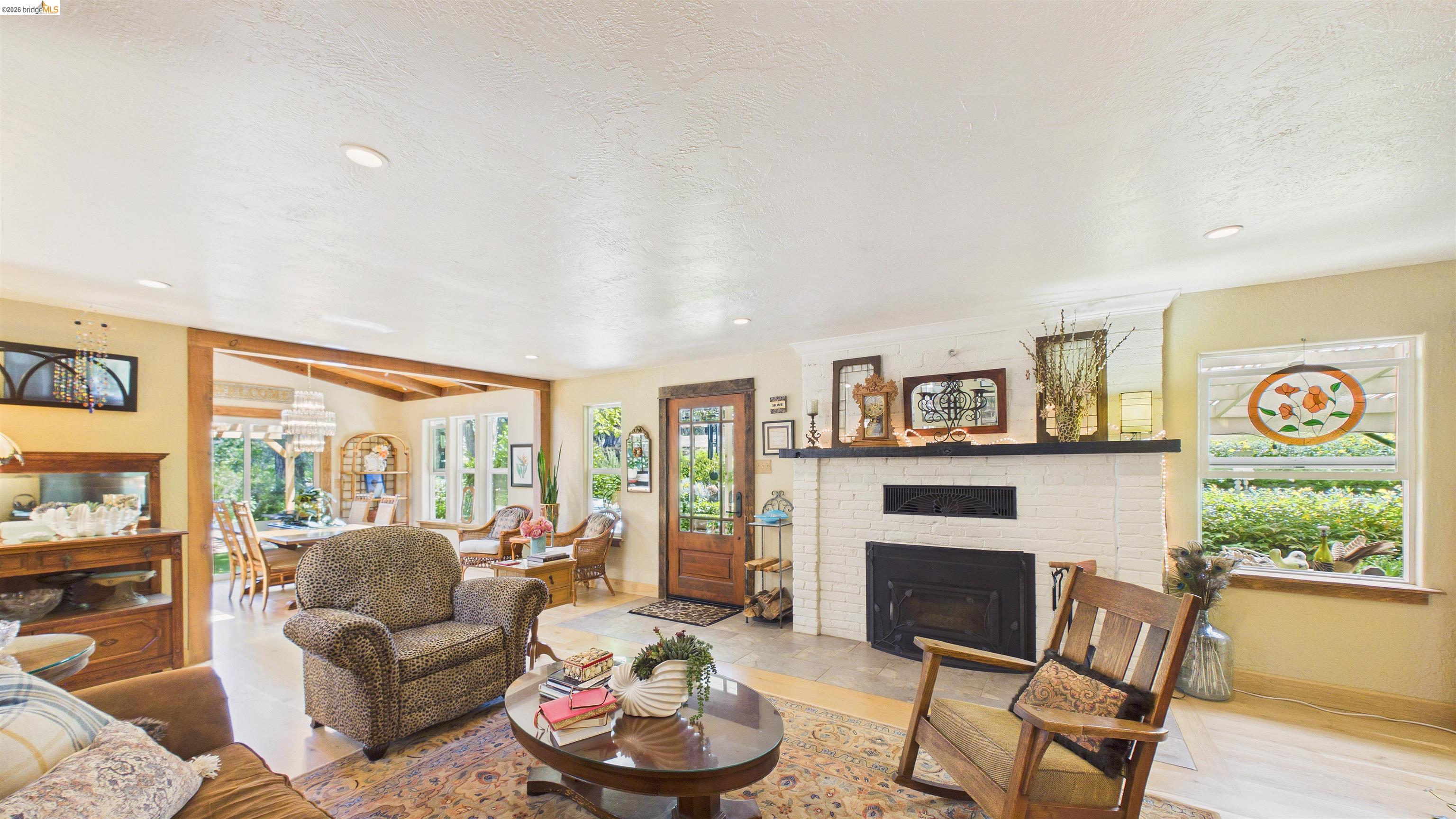 18102 Mt Eaton Road Tuolumne, CA 95379 - Photo 8 of 44 Living area with a white brick fireplace, dark mantel, and recessed lighting