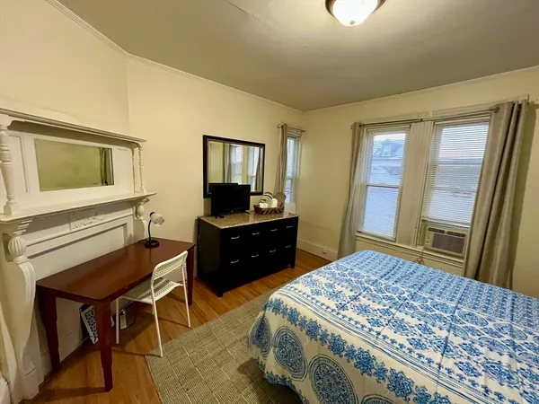 a bedroom with a bed and a dresser
