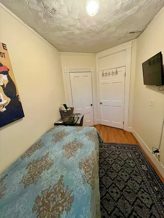 a bedroom with a bed and flat screen tv