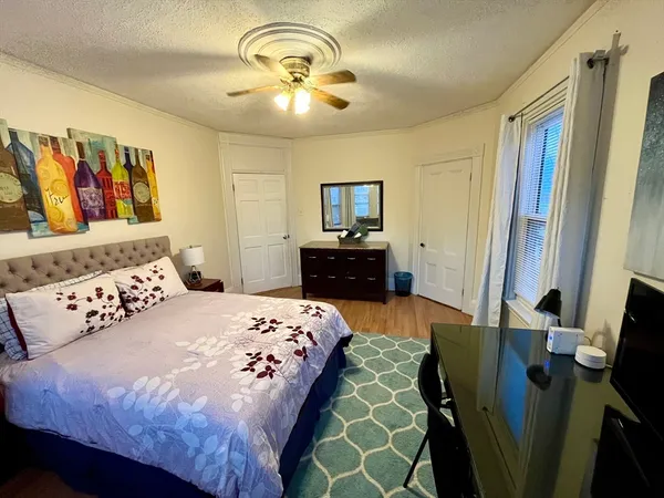 a bedroom with a bed and a chandelier