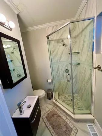 a bathroom with a shower sink and mirror