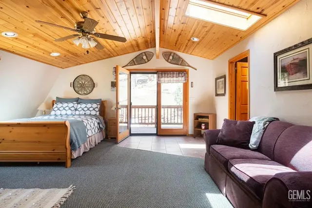 a spacious bedroom with a bed couch and a window