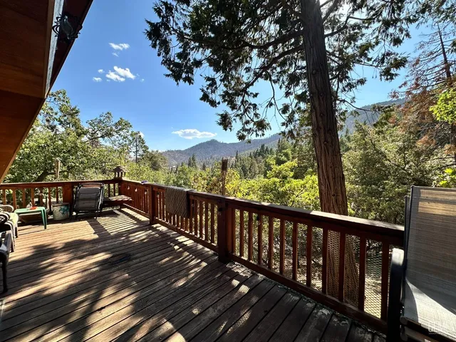 a view of balcony with wooden floor and outdoor seating
