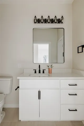 a bathroom with a sink vanity and mirror