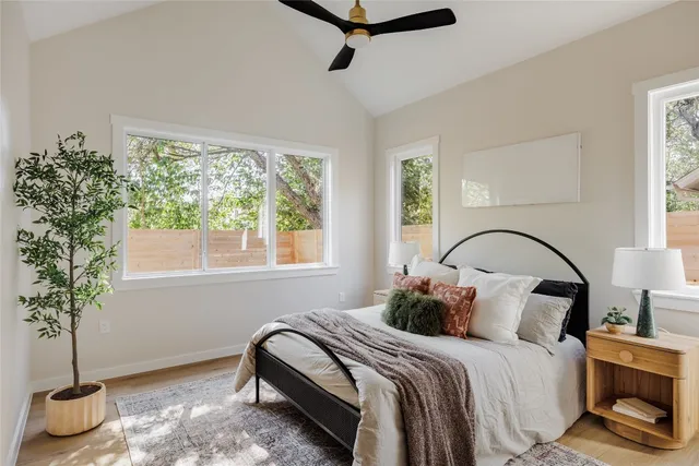 a bedroom with a bed and a potted plant