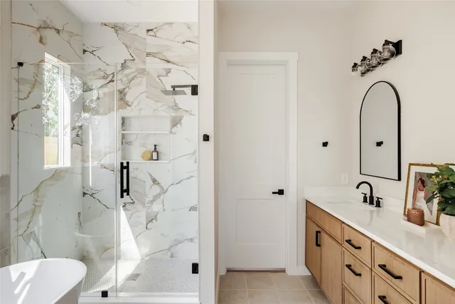 a bathroom with a double vanity sink toilet and shower
