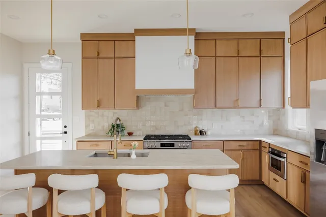 a kitchen with a table chairs stove and cabinets