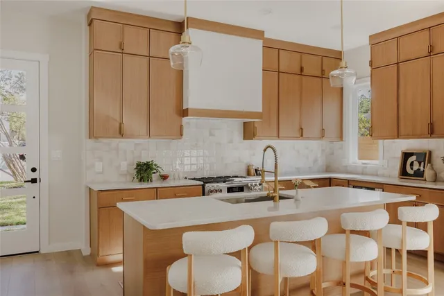 a kitchen with a sink a table and chairs