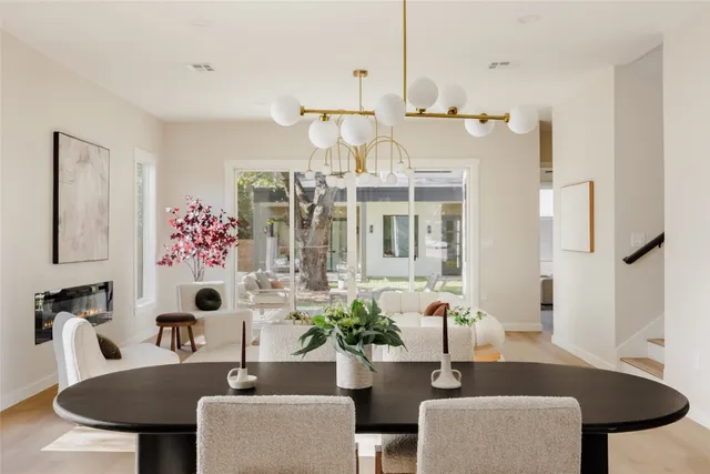 a dining room with furniture and wooden floor