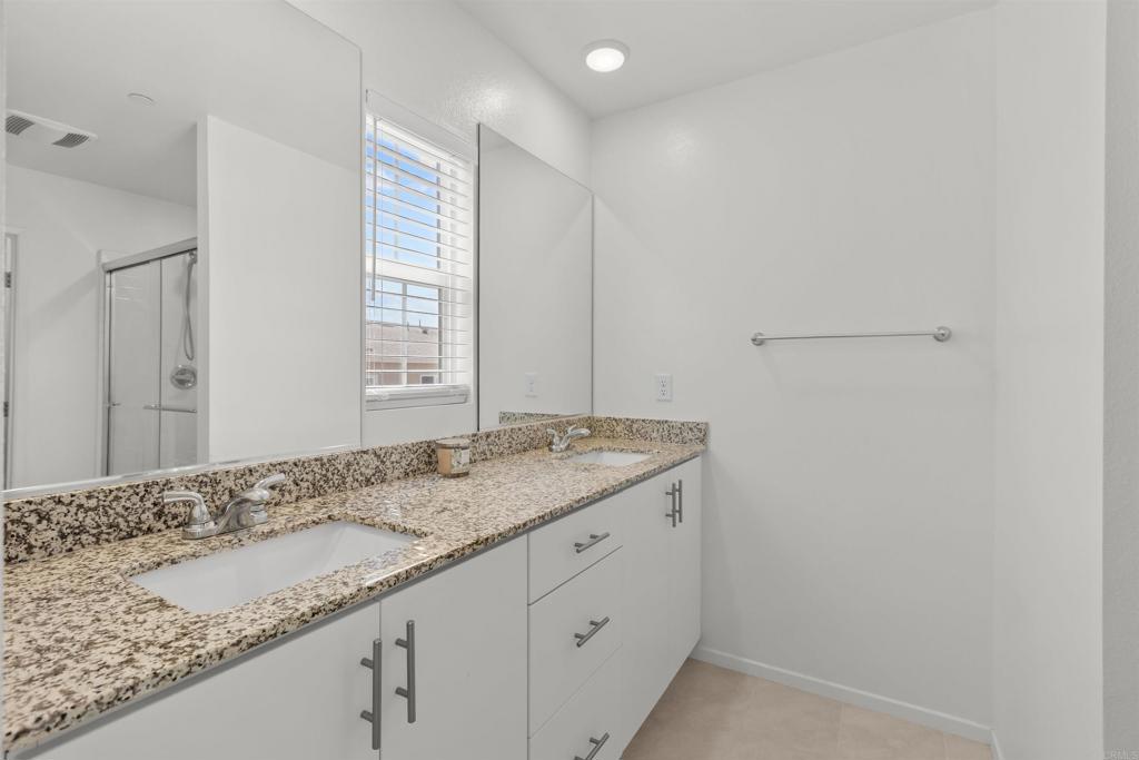 355 Citrine Trail Fallbrook, CA 92028 - Photo 15 of 27 a bathroom with a granite countertop sink and a mirror