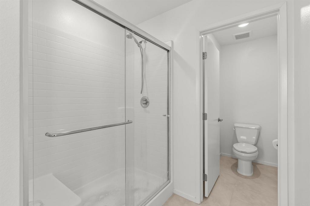 355 Citrine Trail Fallbrook, CA 92028 - Photo 16 of 27 a bathroom with a shower and a toilet