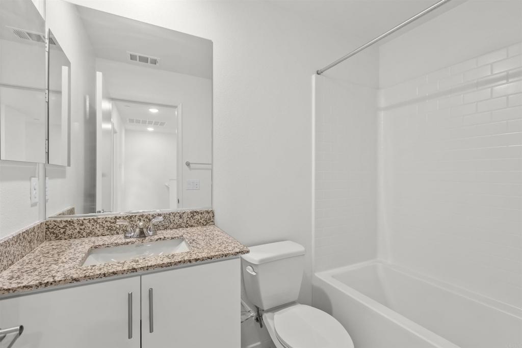 355 Citrine Trail Fallbrook, CA 92028 - Photo 20 of 27 a bathroom with a granite countertop sink toilet and shower