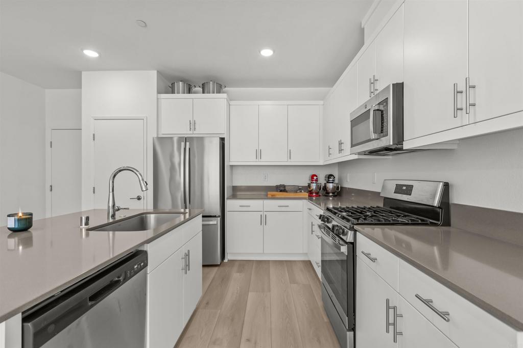355 Citrine Trail Fallbrook, CA 92028 - Photo 10 of 27 a kitchen with stainless steel appliances granite countertop a sink stove and refrigerator