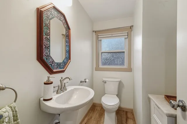 a bathroom with a toilet sink and mirror
