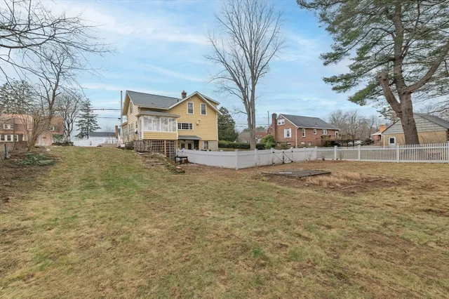 a view of a house with a yard covered with snow