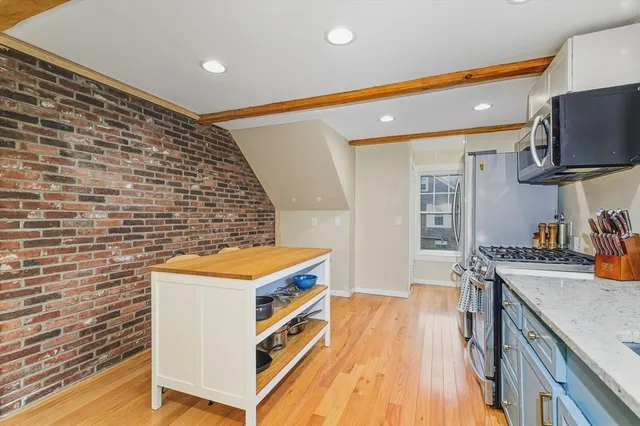 a kitchen that has a sink and a stove in it