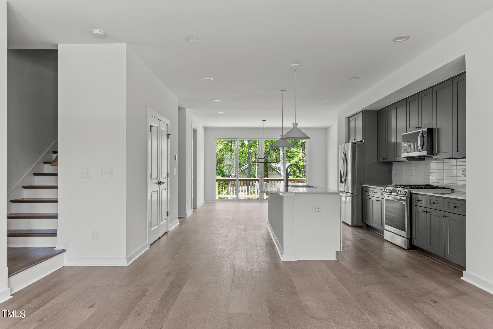 6415 Tanner Oak Lane Raleigh, NC 27613 - Photo 11 of 56 a large kitchen with a large window and stainless steel appliances