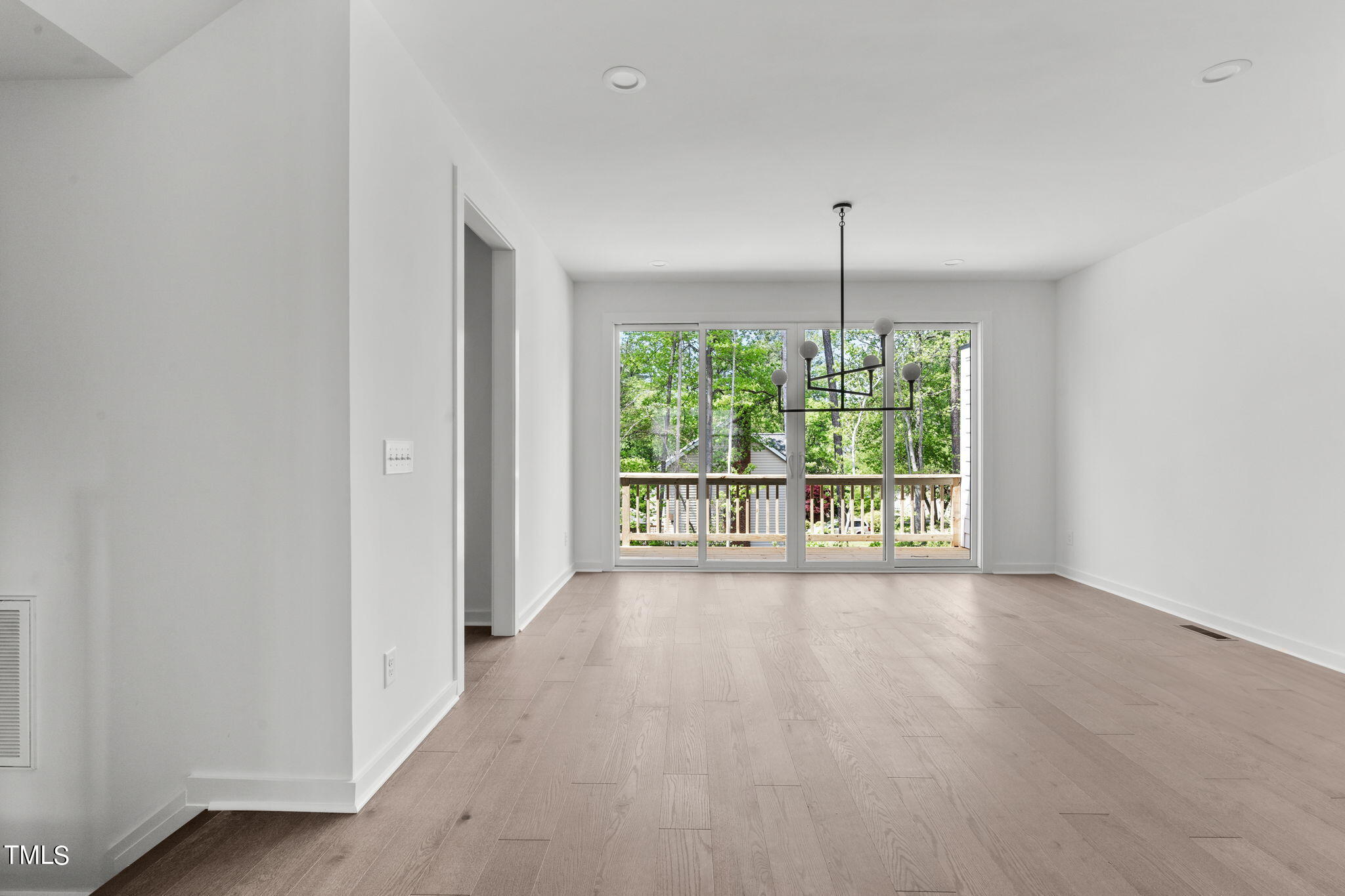 6415 Tanner Oak Lane Raleigh, NC 27613 - Photo 15 of 56 an empty room with windows and outdoor space