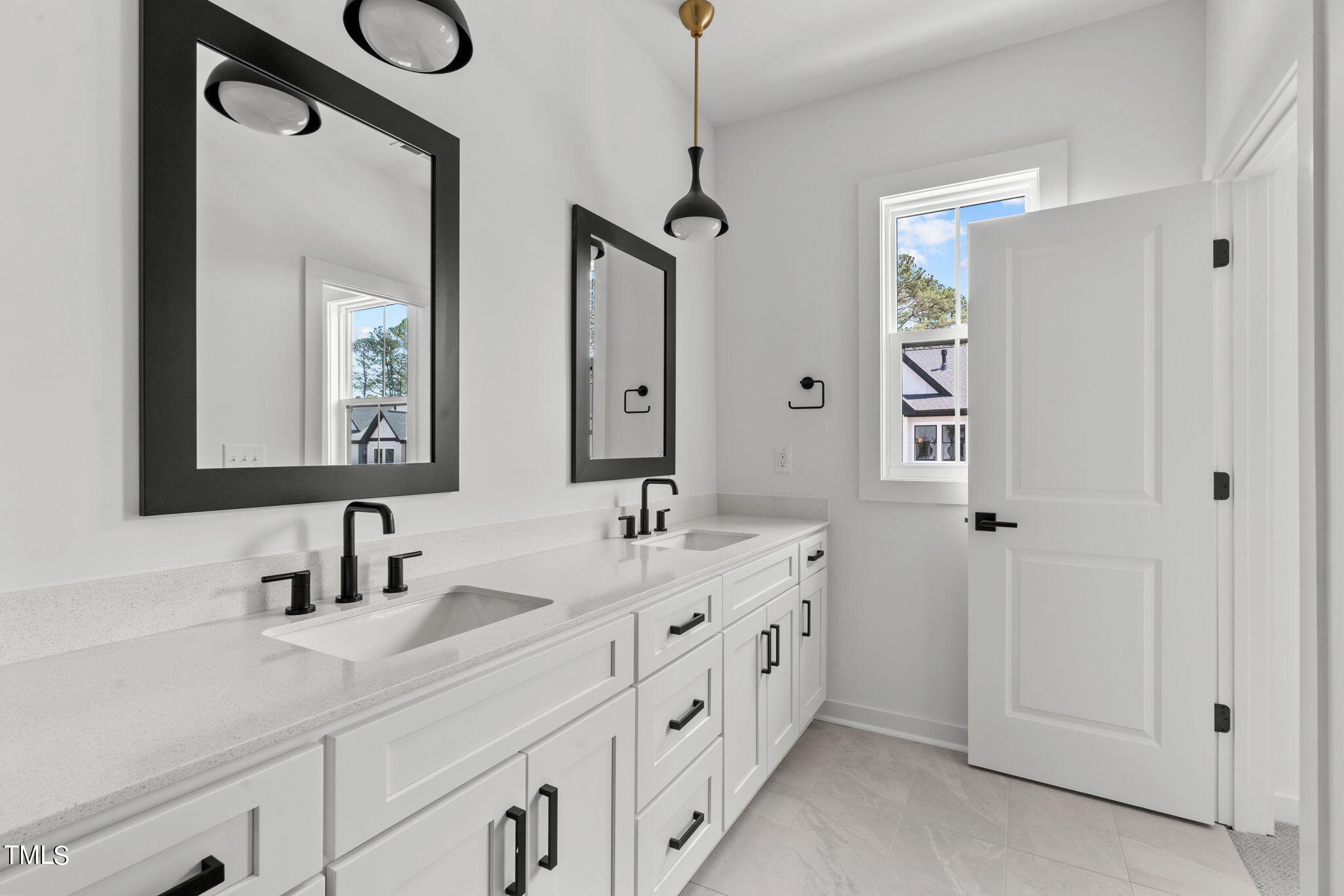 6415 Tanner Oak Lane Raleigh, NC 27613 - Photo 27 of 56 a bathroom with double vanity sink and a mirror