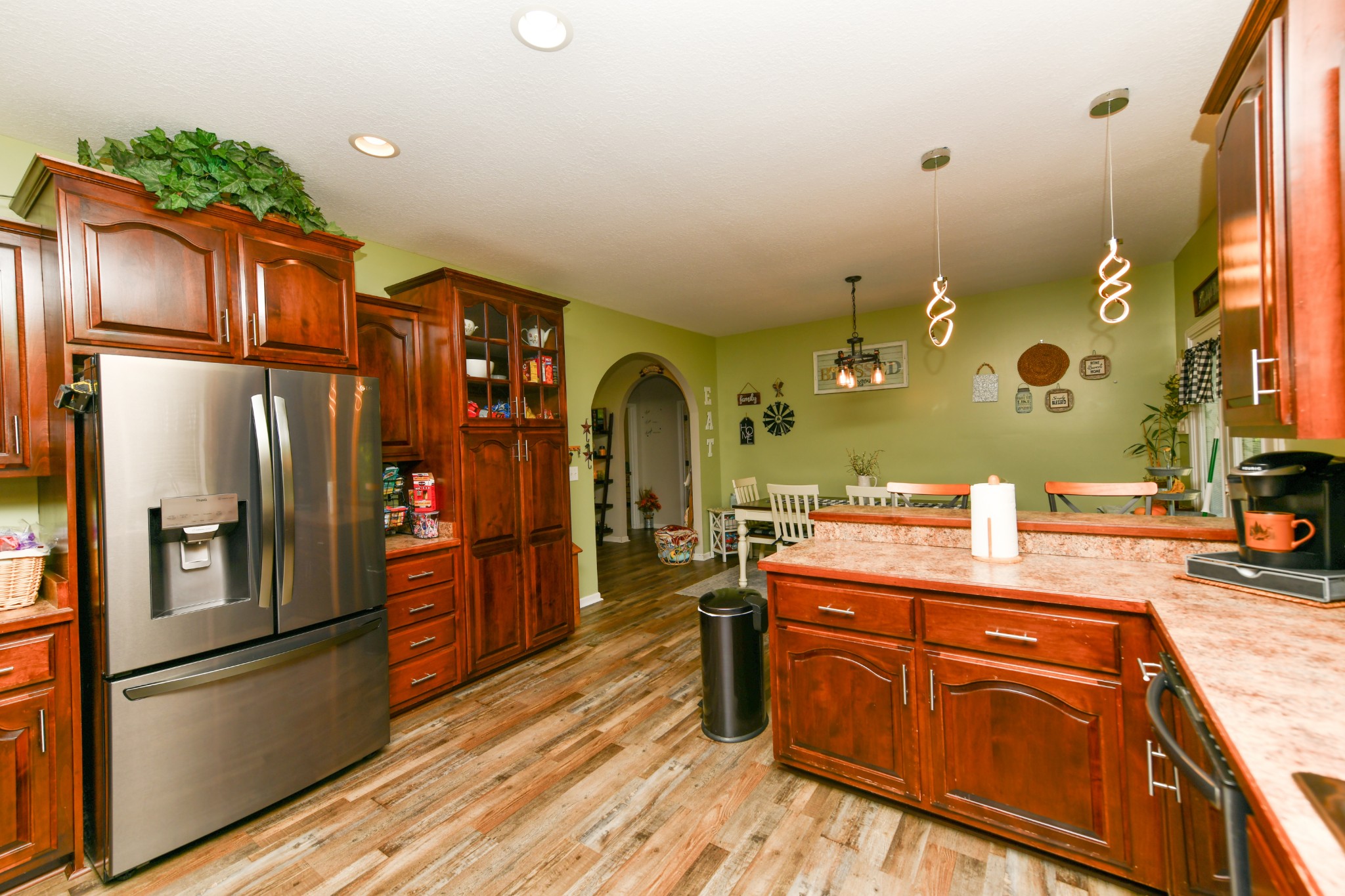 508 Gunson Ridge Road Cumberland City, TN 37050 - Photo 24 of 56 a kitchen with stainless steel appliances granite countertop a refrigerator a sink dishwasher and wooden cabinets with wooden floor