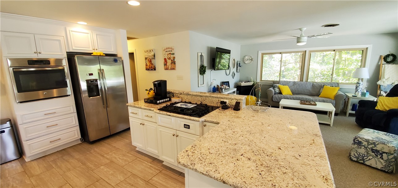 347 Hickory Road Lancaster, VA 22503 - Photo 11 of 48 a kitchen with stainless steel appliances granite countertop a refrigerator a stove and a refrigerator