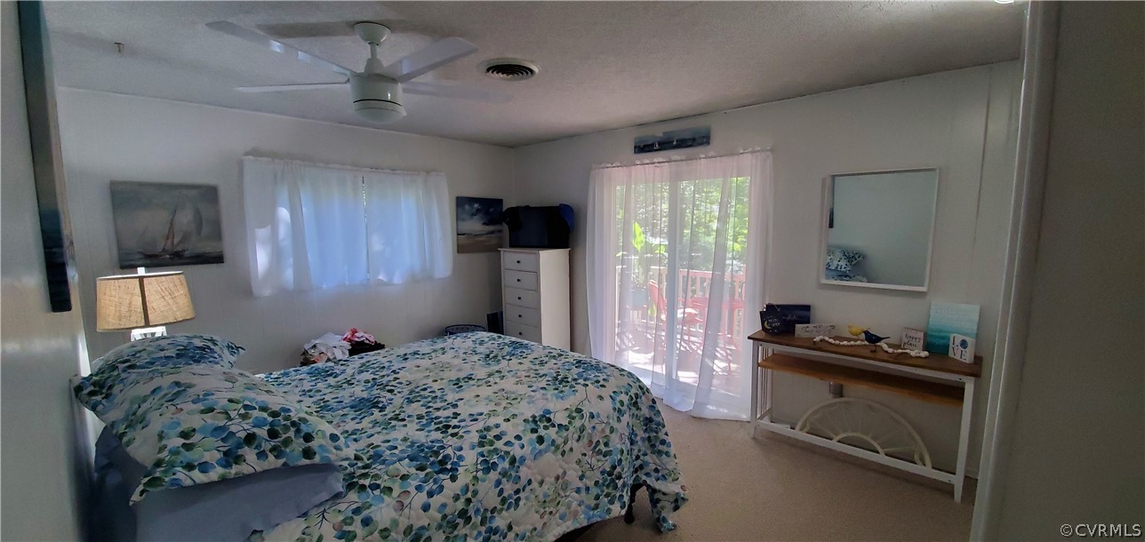 347 Hickory Road Lancaster, VA 22503 - Photo 15 of 48 a bedroom with a bed and a walk in closet