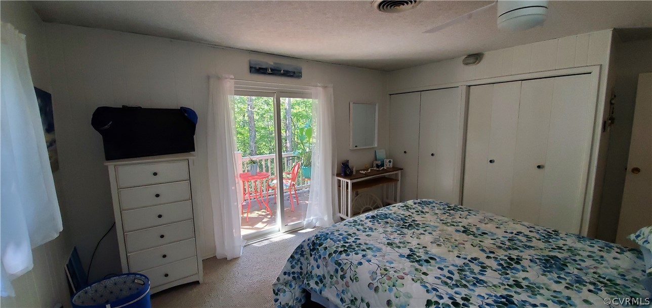 347 Hickory Road Lancaster, VA 22503 - Photo 16 of 48 a bedroom with a bed and a flat tv screen