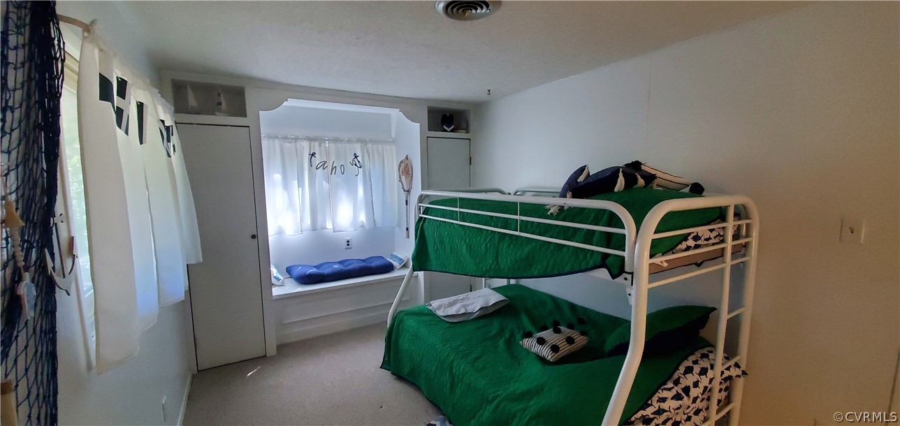 347 Hickory Road Lancaster, VA 22503 - Photo 21 of 48 a bedroom with bed and balcony