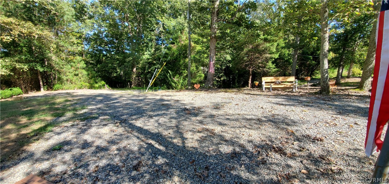 347 Hickory Road Lancaster, VA 22503 - Photo 42 of 48 a backyard of a house with trees and outdoor seating