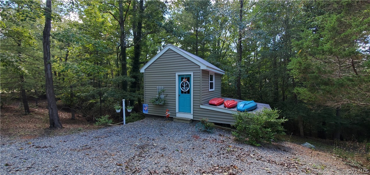 347 Hickory Road Lancaster, VA 22503 - Photo 7 of 48 a backyard of a house with fire pit and outdoor seating
