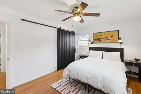 a bedroom with a bed and a painting on the wall