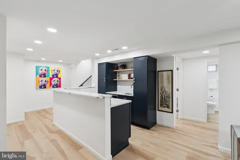 a kitchen with stainless steel appliances kitchen island granite countertop a refrigerator and a sink