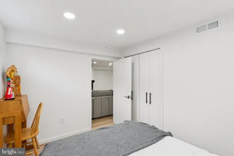a view of a storage & utility room with refrigerator