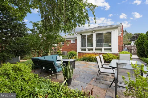 a view of a house with backyard sitting area and garden