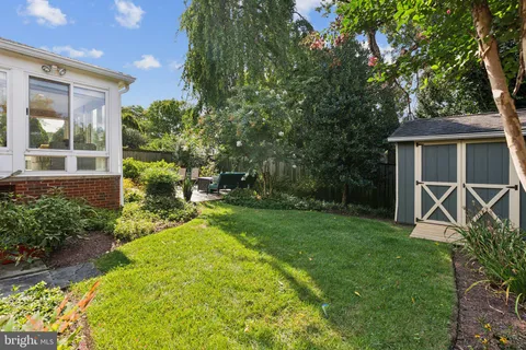 a view of house with backyard and garden