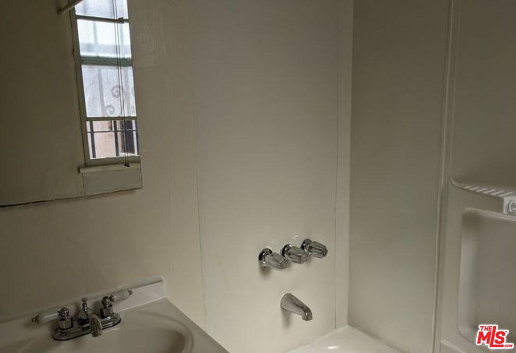 665 South Cochran Avenue, Unit 104 Los Angeles, CA 90036 - Photo 3 of 8 a bathroom with a sink and a window